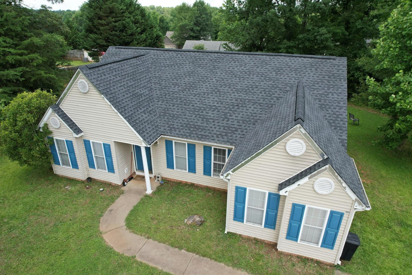 Single-story ranch home with blue shutters and a shingle roof, Upstate SC