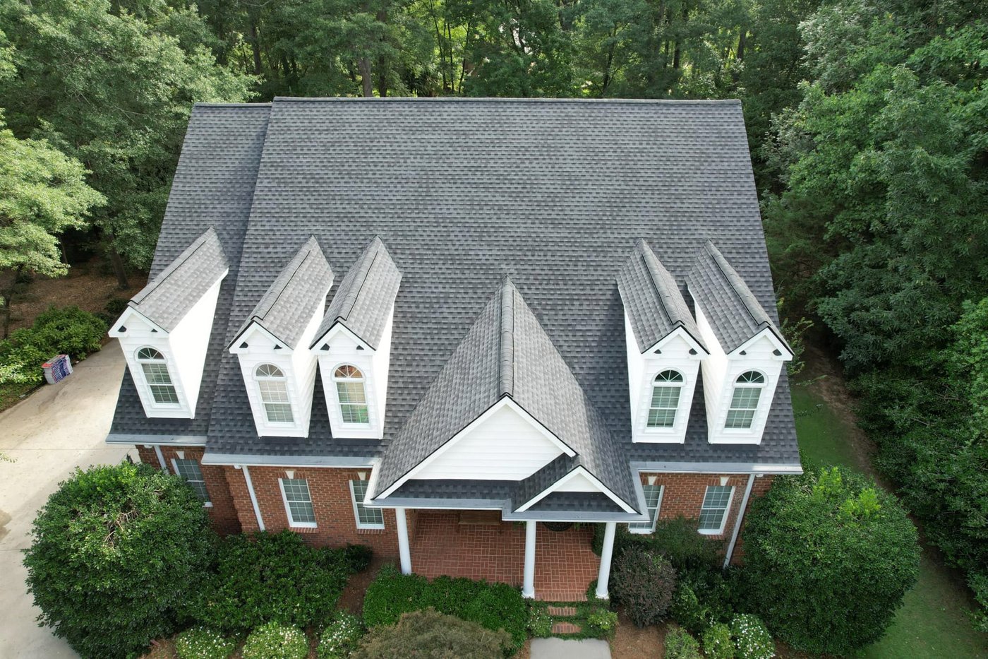 Brick two-story home with five dormers and a shingle roof, Upstate SC