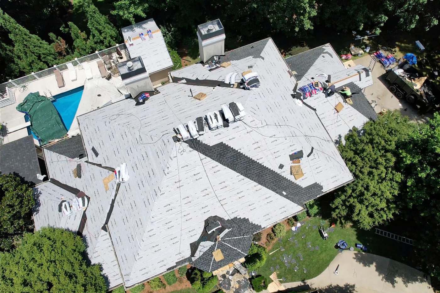 Drone view of new underlayment on a large home with a pool before shingles, Upstate SC