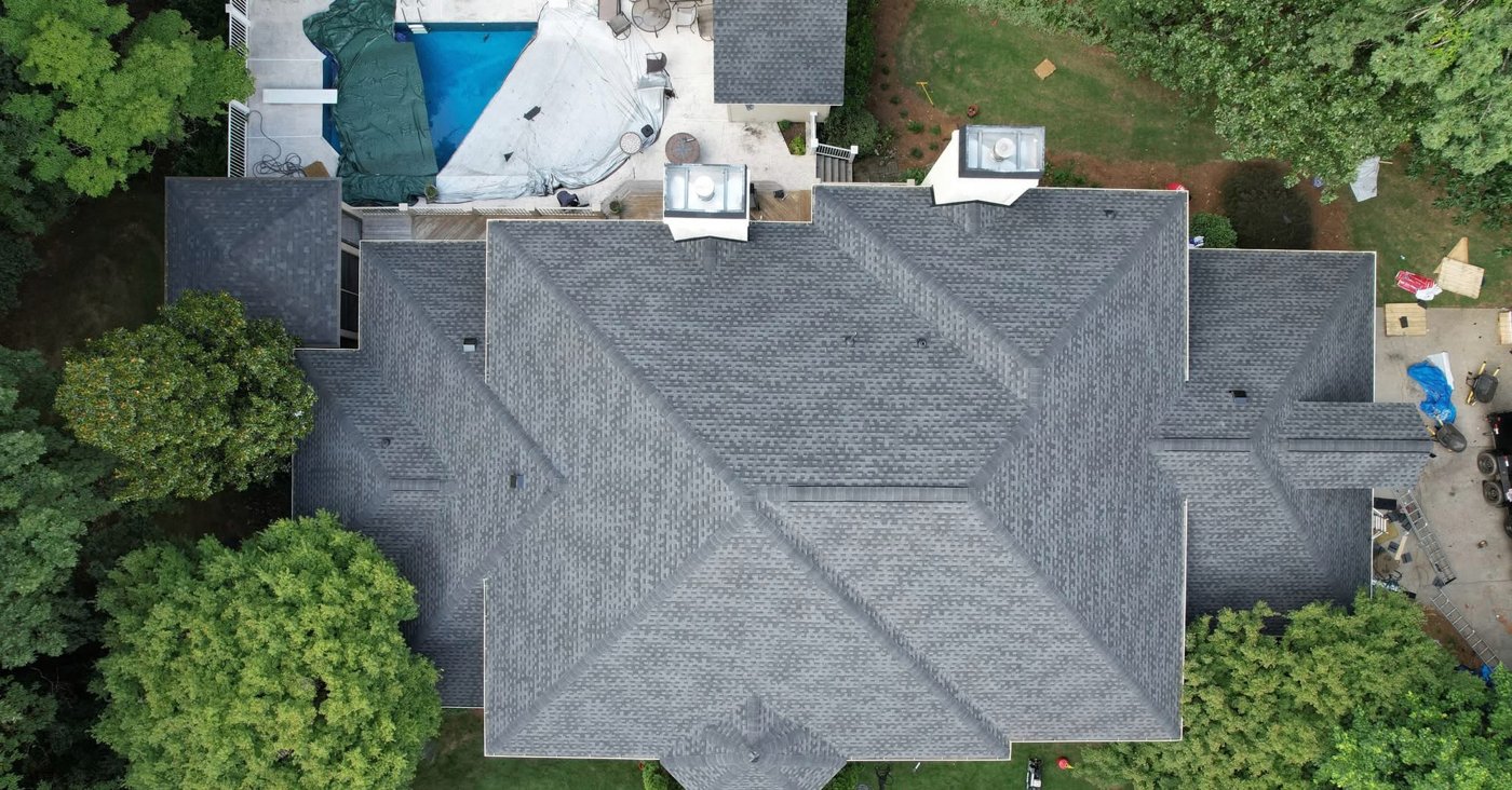 Drone view of a large home with a pool and architectural shingle roof, Upstate SC